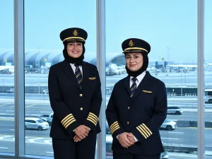 Emirates first Emirati women pilots Boeing 777 — Hanan Mohammed Jawad and Bakhita Al Mheiri in Emirates captain uniform after receiving fourth stripe at Dubai International Airport