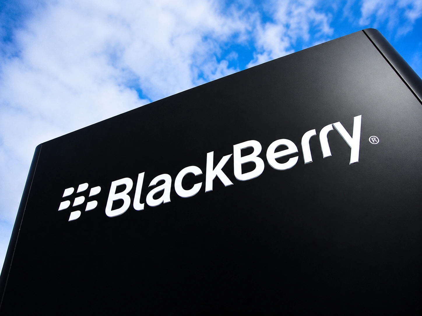 Advanced automated assembly arms operating smoothly in a high-tech facility, showcasing the real-time embedded systems driving the BlackBerry comeback.